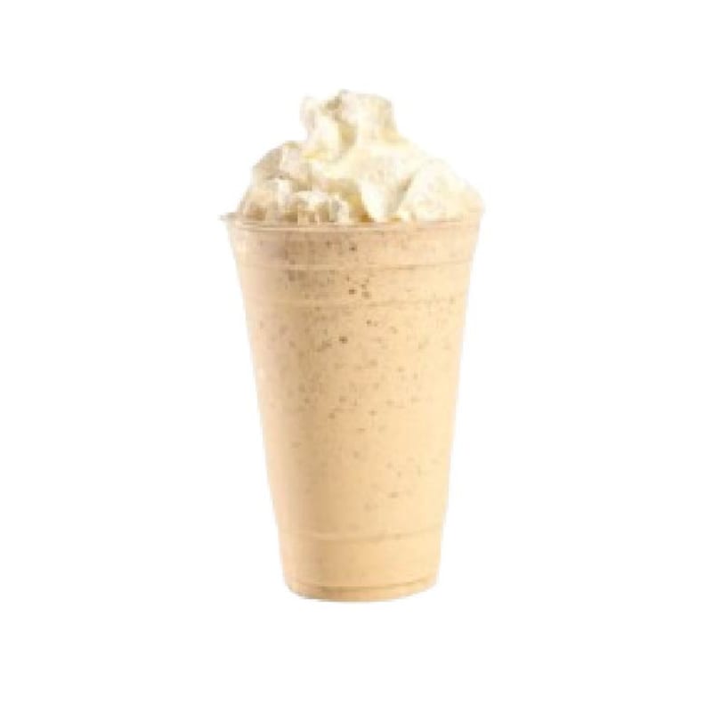 A Peri Peri Original milkshake, light brown with whipped cream, in a clear plastic cup.